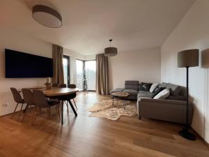 a living room with a couch and a table at BlackDEER Apartment Liptov in Liptovský Mikuláš