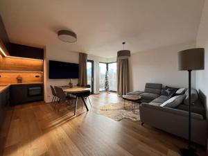 a living room with a couch and a table at BlackDEER Apartment Liptov in Liptovský Mikuláš +72 photos