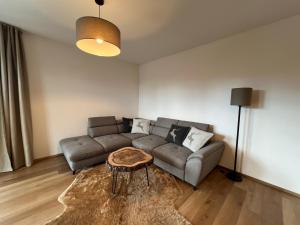 a living room with a couch and a table at BlackDEER Apartment Liptov in Liptovský Mikuláš