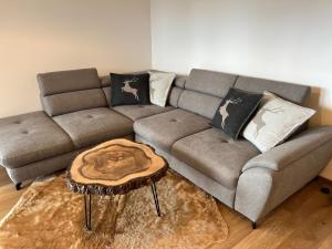 a living room with a couch and a coffee table at BlackDEER Apartment Liptov in Liptovský Mikuláš
