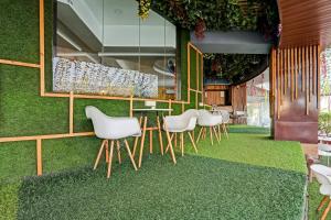 a dining room with a table and chairs on grass at OYO Salt House in Mumbai