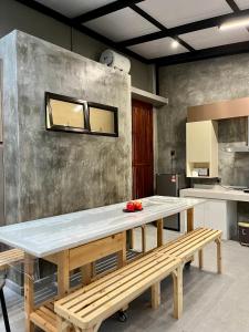 a kitchen with a large table and a bench at Traveler's Stay @ Ipoh (10Pax) in Ipoh