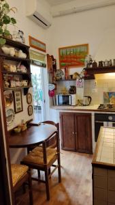 a kitchen with a table and a dining room at Tre Gigli Firenze BB, 5 minutes from station, via Palazzuolo 55 in Florence