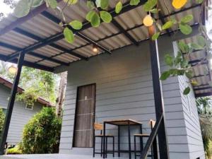 a porch of a house with a patio at family resort in Ko Phayam +2 photos