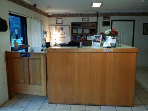 a kitchen with a large wooden island in a room at Loyalty Inn Rockingham in Rockingham