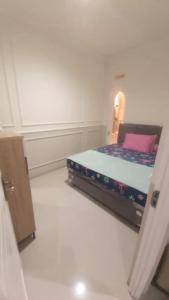 a small bedroom with a bed in a room at Kavilla2 Regency in Karangploso +7 photos
