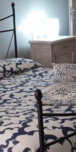 a bedroom with a bed with a black and white comforter at Margot Ca Bianca Dormelletto Lago Maggiore in Dormelletto