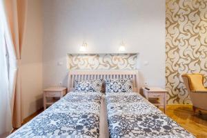 a bedroom with a large bed with blue and white sheets at Standard Apartment by Hi5 - Rumbach - Synagogue in Budapest
