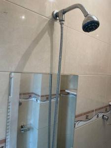 a shower with a shower head in a bathroom at Loft funcional in Rio de Janeiro