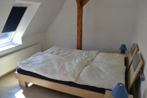 a bedroom with a bed with a wooden head board at Immensee App F in Ehst