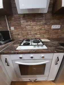 a white stove top oven in a kitchen at Comfortable Apartment in Kremenchuk