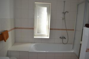 a bathroom with a bath tub and a window at Immensee App A in Ehst