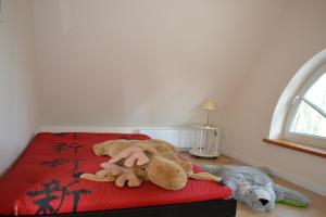 uma cama com um monte de bichos de peluche em Friesenhus em Katingsiel