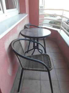 a table and a chair sitting on a balcony at Apartman in Trebinje