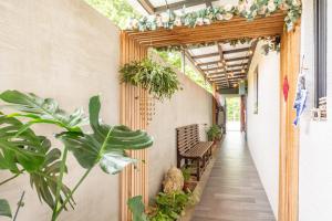 a walkway with plants and a bench in a hallway at 水蛙春 in Hengchun South Gate