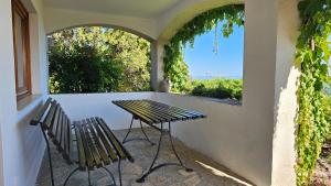 a patio with a table and two chairs and a window at Panorama Apartment in Tihany