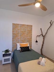a bedroom with a green bed with a ceiling fan at Finca Chimaca in Arona