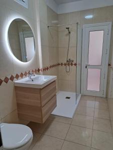 a bathroom with a shower and a sink and a toilet at Finca Chimaca in Arona