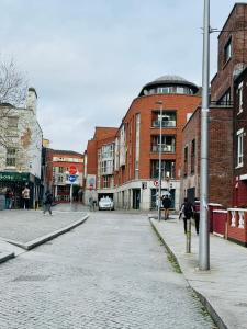 an empty street in a city with buildings at Smithfield square Nest in Dublin