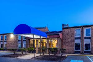 a building with a blue canopy in front of it at Days Inn by Wyndham Manassas Battlefield in Manassas