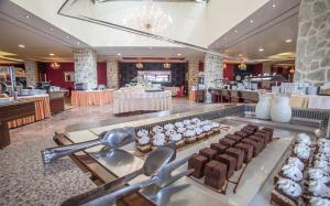 a restaurant with chocolate desserts on display in a store at Hotel Palas in Petrovac na Moru