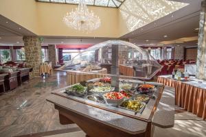 a buffet in a restaurant with food on a table at Hotel Palas in Petrovac na Moru