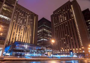 a group of tall buildings in a city at night at Hyatt Regency Chicago in Chicago