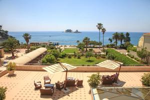 a view of a park with chairs and the ocean at Hotel Palas in Petrovac na Moru