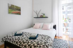 a bedroom with a bed with two towels on it at Lea and Maks's City Apartment URBAN STAY in Zagreb