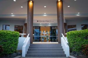 a building with columns and stairs in front of it at DoubleTree by Hilton Cairns in Cairns