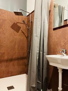 a shower curtain in a bathroom with a sink at Malak-Rooms in Málaga