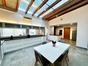 a large kitchen with a white table and chairs at Casa Beloura between the sea and the mountains in Sintra