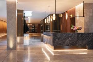 a lobby with a marble counter with a vase of flowers at Parmelia Hilton Perth in Perth