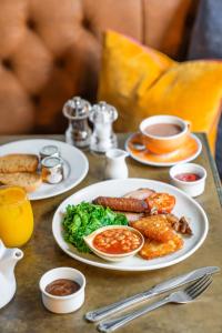 a table with plates of breakfast food on it at The Clifton Hotel Bristol in Bristol +36 photos