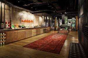 a lobby with a bar and a red rug at DoubleTree by Hilton Melbourne in Melbourne