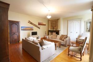 a living room with two couches and a tv at Le Belvedere in Salles