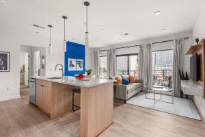 an open kitchen and living room with a couch at Hyve in Nashville