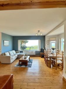 a living room with a couch and a table at The Surf House (Widemouth Bay) in Bude