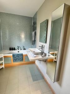 a bathroom with a sink and a tub and a mirror at The Surf House (Widemouth Bay) in Bude +21 photos