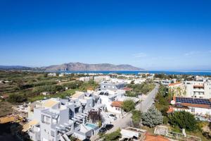 an aerial view of a town with white buildings and the ocean at Akonizia Luxury House - With Private Heated Pool and Jacuzzi in Dhrámia