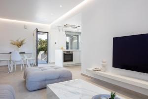 a living room with a large flat screen tv at Akonizia Luxury House - With Private Heated Pool and Jacuzzi in Dhrámia