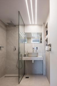 a bathroom with a sink and a shower at Akonizia Luxury House - With Private Swimming Pool in Dhrámia