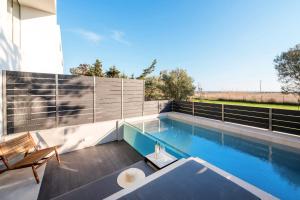 a swimming pool on the roof of a house at serene villas halkidiki - Cfront private pool in Epanomi