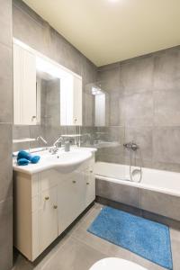 a bathroom with a sink and a tub and a toilet at Athens Kyniska Urban Apartment in Athens