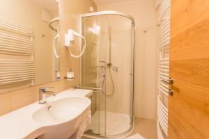 a bathroom with a sink and a shower at Lake Peak Apartments, Ribniško Pohorje in Ribnica na Pohorju +69 photos