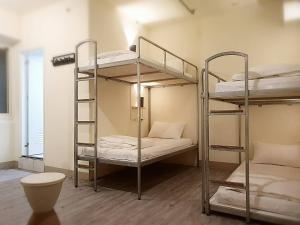 a room with three bunk beds in a room at COZY Home in Taipei