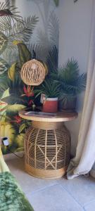 a table with a basket and plants on a wall at Chambre d'hôtes Chante Cigale in La Ciotat