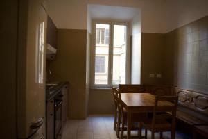 a kitchen with a table and chairs and a window at Lavinia Apartment In Trastevere in Rome +17 photos