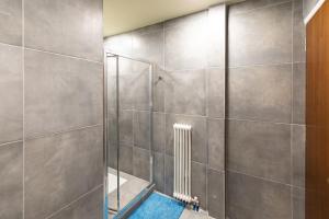 a bathroom with a shower with a glass door at Athens Kyniska Urban Apartment in Athens