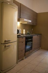 a kitchen with a refrigerator and a stove at Lavinia Apartment In Trastevere in Rome